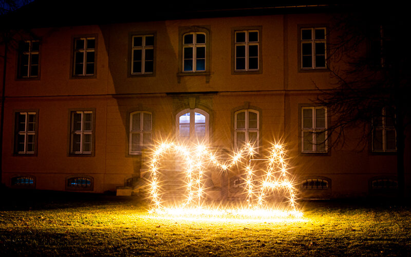 weihnachtlich beleuchteter Schriftzug vor dem Schloss: "OMA"